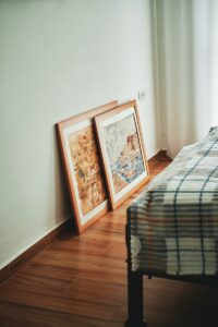 brown wooden framed painting on white wall