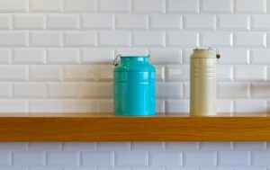 two teal and brown metal cans on shelf
